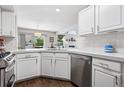 Bright kitchen featuring white cabinets, stainless steel appliances, quartz countertops, and modern finishes at 4976 S Nelson St # A, Littleton, CO 80127