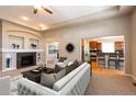 Open living room with a view of the kitchen and fireplace at 26433 E Caley Dr, Aurora, CO 80016