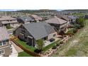 Backyard view features a well maintained fenced lawn with mature trees and a cozy outdoor patio area at 1815 Avery Way, Castle Rock, CO 80109