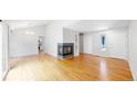 Bright living room featuring hardwood floors, a fireplace and an entry door at 1006 Homestake Dr # 1D, Golden, CO 80401