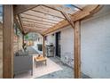 Cozy backyard patio with wooden pergola, outdoor seating, and stainless steel grill at 1362 Wolff St, Denver, CO 80204