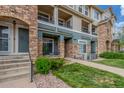 Condo exterior showcasing stone accents, well-kept lawns, and sidewalks leading to welcoming entrances at 457 Black Feather Loop # 702, Castle Rock, CO 80104