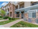 Attractive condo exterior featuring stone accents, well-maintained landscaping, and inviting walkways at 457 Black Feather Loop # 702, Castle Rock, CO 80104