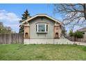 Home with brick details and updated landscaping featuring uplighting in the front yard at 2272 Jay St, Edgewater, CO 80214
