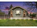 Home with brick details and updated landscaping featuring uplighting in the front yard at 2272 Jay St, Edgewater, CO 80214