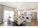 Bright dining area adjacent to a modern kitchen with stainless steel appliances at 6506 13Th St, Frederick, CO 80530
