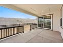 Relaxing covered back patio with sliding glass doors and a fenced-in backyard, perfect for outdoor living at 3370 Backdrop Ct, Castle Rock, CO 80108