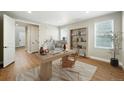 Cozy home office with a modern desk, stylish chair, and built-in shelving at 3370 Backdrop Ct, Castle Rock, CO 80108