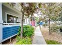 Inviting walkway to the home with lush landscaping, gravel accents, and a charming front porch at 1372 S Cathay Ct # 104, Aurora, CO 80017