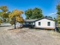 Inviting home featuring a spacious deck, lush greenery, and a serene outdoor setting at 6365 W Coal Mine Ave, Littleton, CO 80123