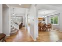 Spacious entryway with hardwood floors that lead to a staircase and dining room at 15357 Flowergate Way, Parker, CO 80134