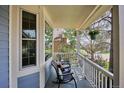 Inviting front porch with rocking chairs and a hanging flower basket; perfect for relaxing at 15357 Flowergate Way, Parker, CO 80134