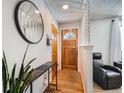 Bright entryway with wood floors, a half wall, and a large mirror at 9235 Quitman St, Westminster, CO 80031