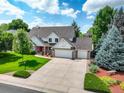 Beautiful two-story home with well-kept lawn, three-car garage and front yard landscaping at 20829 Parliament Ct, Parker, CO 80138