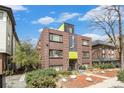 A cozy brick apartment building stands with unique architectural facade and landscaping at 1977 S Josephine St # 101, Denver, CO 80210