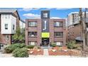 Classic brick apartment building featuring a prominent facade and lush landscaping at 1977 S Josephine St # 101, Denver, CO 80210