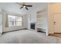 Cozy living room with a fireplace, built-in shelves, and a large window that offers ample natural light at 9180 Rolling Way # 303, Parker, CO 80134