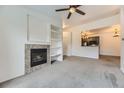 Living room featuring a fireplace and view into the kitchen at 9180 Rolling Way # 303, Parker, CO 80134