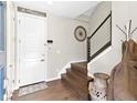 Welcoming foyer features a staircase, coat rack, and stylish decor, creating a warm entry at 2578 Palau Way, Castle Rock, CO 80109