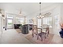 Bright and airy living room with carpeted floors, large windows, and an adjacent dining area at 3742 E 127Th Ln, Thornton, CO 80241