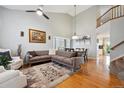 Open-concept living room and dining area featuring hardwood floors and ample natural light at 2529 S Truckee Way, Aurora, CO 80013