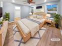 A serene main bedroom features a large window, plush rug, and hardwood floors at 27699 E 7Th Ln, Aurora, CO 80018
