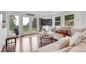 Bright living room with hardwood floors, white couch, and mountain views at 509 Paiute Rd, Evergreen, CO 80439
