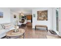 Cozy living space featuring a view to the kitchen and a rustic accent wall at 509 Paiute Rd, Evergreen, CO 80439
