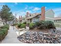 Beautiful landscaping adorns the front of these homes with green bushes and decorative rock features at 2019 S Hannibal St # C, Aurora, CO 80013