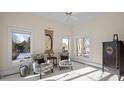 Bright sitting area with two armchairs and large windows at 7172 Waterford Ct, Niwot, CO 80503