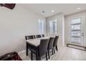 Small dining area with marble table and four black chairs at 9643 Truckee St, Commerce City, CO 80022