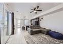 Open living room featuring L-shaped sofa and view of kitchen at 9643 Truckee St, Commerce City, CO 80022