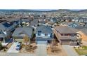 View of a suburban neighborhood showcasing well-maintained homes and scenic mountain views at 3111 Youngheart Way, Castle Rock, CO 80109
