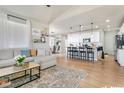 Open-concept layout shows living room and kitchen with breakfast bar seating at 3111 Youngheart Way, Castle Rock, CO 80109