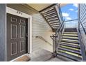 Apartment entry with gray door, unit number, and exterior staircase at 2575 S Syracuse Way # H206, Denver, CO 80231