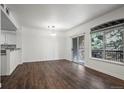 Open concept living space with wood floors, natural light, and kitchen access at 2575 S Syracuse Way # H206, Denver, CO 80231