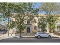 Elegant brick apartment building showcases mature trees and a well-maintained facade, reflecting timeless charm and appeal at 1284 N Corona St # B6, Denver, CO 80218