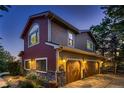 Spacious three-car garage with beautiful wood doors, stone accents and well-maintained landscaping at 25779 E Jamison Cir, Aurora, CO 80016