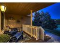 Cozy covered porch featuring comfortable seating, decorative rug, and scenic outdoor view at 25779 E Jamison Cir, Aurora, CO 80016