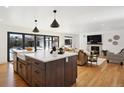 Modern kitchen with a large island and opens to the Gathering room at 625 S Monroe Way, Denver, CO 80209