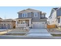 Charming two-story home featuring a covered porch, gray siding, stone accents and a two car garage at 2690 E 102Nd Pl, Thornton, CO 80229