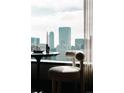 Cozy dining area with city skyline views and modern chair at 1133 14Th St # 3420, Denver, CO 80202