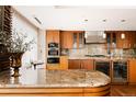 Gourmet kitchen featuring custom cabinetry, granite countertops, and a beverage cooler at 1133 14Th St # 3420, Denver, CO 80202
