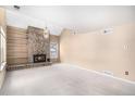 Spacious living room features a stone fireplace, built-in shelving, and a large window at 2141 S Victor St # B, Aurora, CO 80014