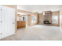Open-concept living room with fireplace, built-in shelving, and a doorway to the exterior at 2141 S Victor St # B, Aurora, CO 80014