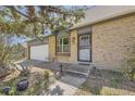 Inviting home exterior with a well-maintained front yard, showcasing a brick facade and an attached garage at 14742 E Radcliff Pl, Aurora, CO 80015