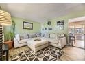 Cozy living room featuring a large sectional sofa, stylish rug, and neutral decor creating an inviting atmosphere at 14742 E Radcliff Pl, Aurora, CO 80015
