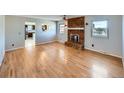 Bright living room with hardwood floors and a cozy brick fireplace, perfect for Gathering gatherings at 1467 S Kenton St, Aurora, CO 80012