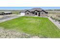 Single-story home with a spacious yard and detached barn at 45425 Wolf Creek Dr, Bennett, CO 80102