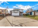 Two-story house with attached garage and basketball hoop at 6119 Zenobia Ct, Arvada, CO 80003